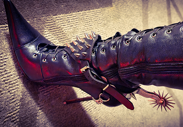 Close up of Vinyl Queen's knee high leather boots by Charlotte Luxury with spurs by Wicked Evil.