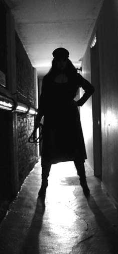 Vinyl Queen waits for you in a darkened hallway.